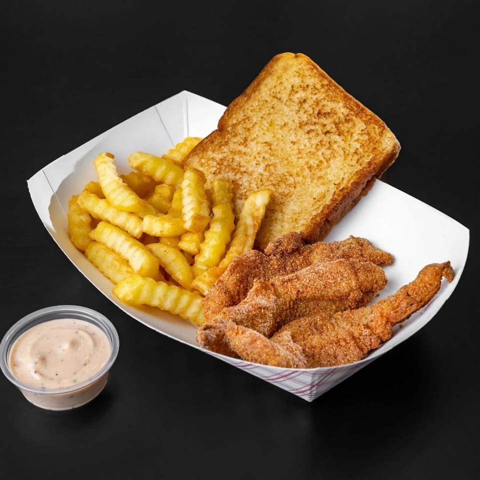 Jim Bob's Chicken Fingers meal with crinkle-cut fries, Texas toast, and dipping sauce.
