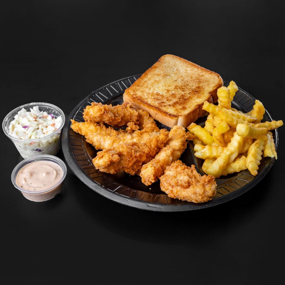 Jim Bob's Chicken Fingers meal with fries, toast, coleslaw, and dipping sauce on a black plate.